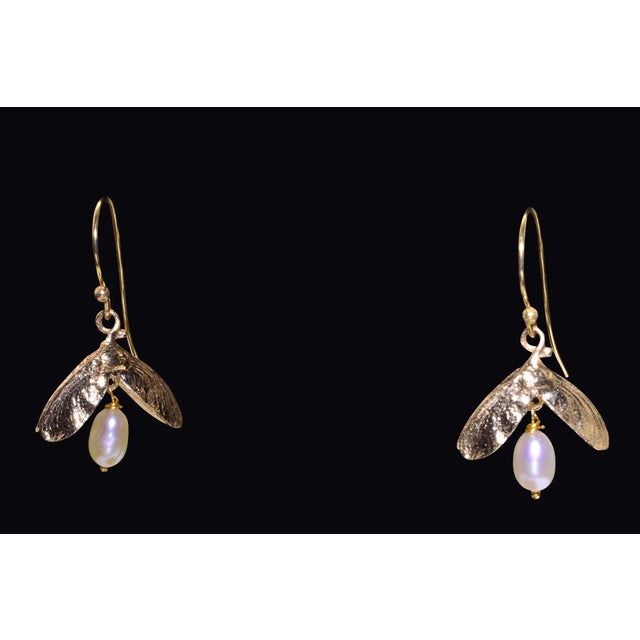 The Bay View Ave: Mid Century Yellow Gold Bug Earrings. The earrings feature a dangling freshwater cultured pearl bottom...