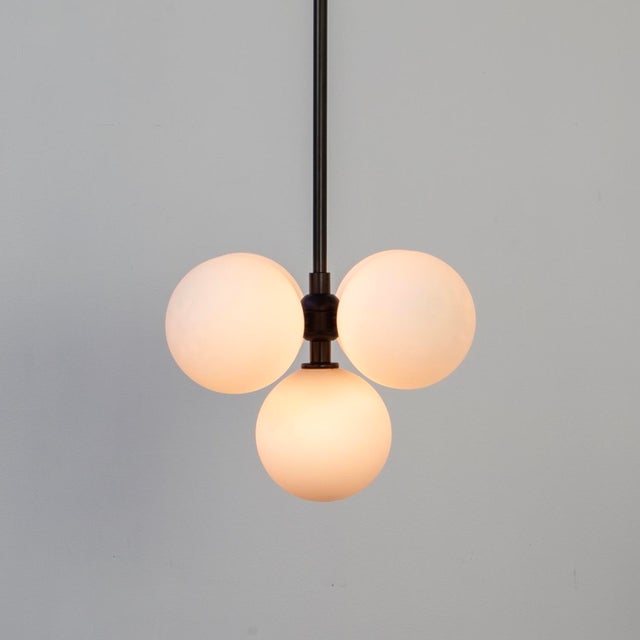 Five glowing orbs float in balance - a radiant cluster of glass and charm. Minimal, magical, and just the right amount of...