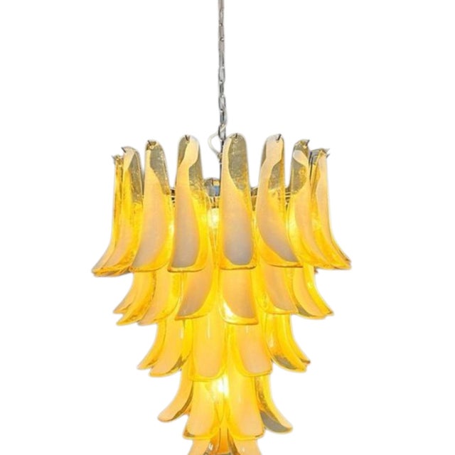 Suspended like a cascade of golden light, this amber-colored Murano chandelier is born from the encounter between master...