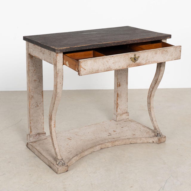 19th century Swedish Gustavian style console table, crafted in pine with a combination of older gray paint and a...