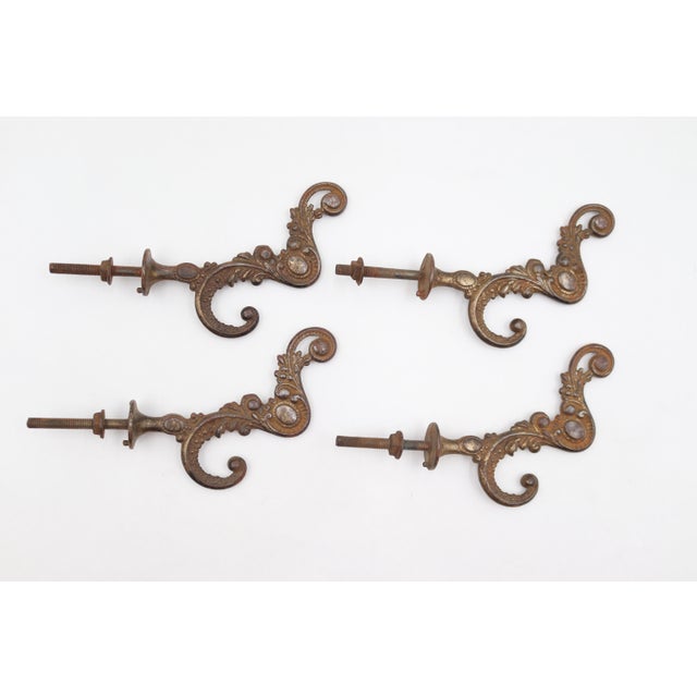 Victorian style hall tree hook made of cast iron with brass plating. There is a screw attached to the back with a nut for...