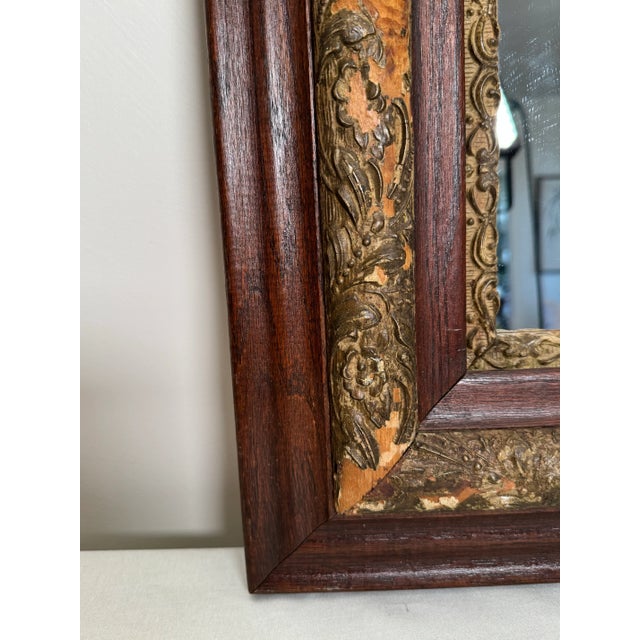 This late 19th century solid wood oak frame has been repurposed into a mirror with a rich walnut brown stained finish. The...