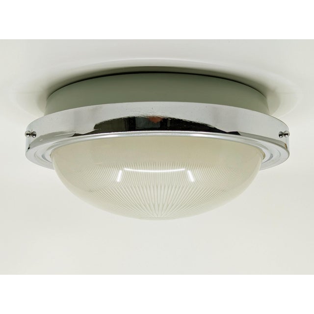 A beautiful circular ceiling light from the 1960s, produced in the style of Sergio Mazza for Artemide. It features a...