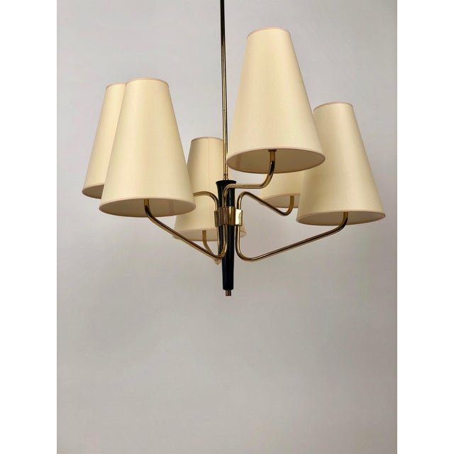 Large pendant lamp with brass arms and blackened corpus. Six silk shades positioned on three levels giving the lamp a...