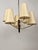 Large pendant lamp with brass arms and blackened corpus. Six silk shades positioned on three levels giving the lamp a...