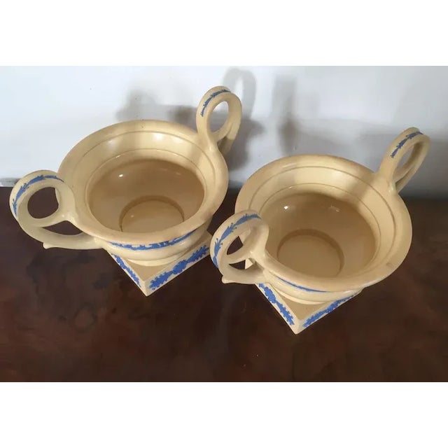 Pair antique early 19th c. Wedgwood neoclassical vase urns of Kantharos shape. Each decorated with blue sprigging on an...