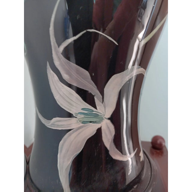 This is an absolutely stunning black decoupage hurricane table lamp done in the early 1980s by an artisan Journeyman from...