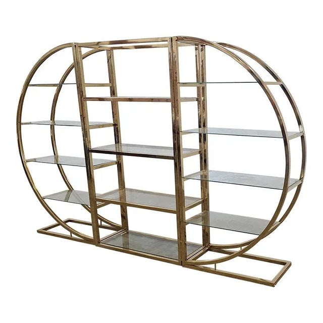 Shelf with brass structure, divided into three modules, the central rectangular and round side ones. Smoked glass shelves....