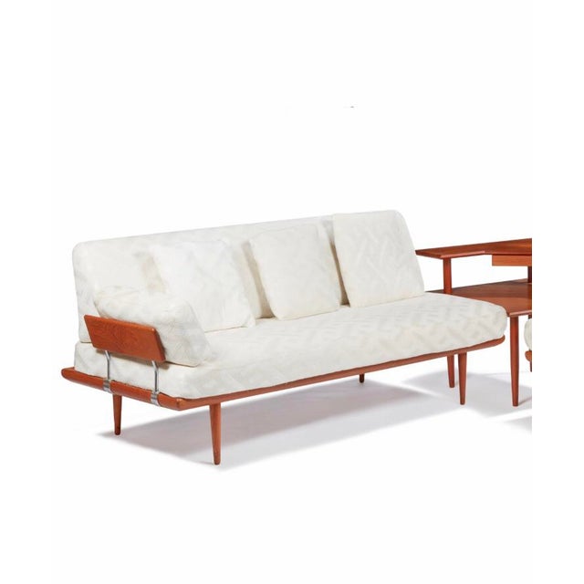 A mid-century modern sectional set comprising three pieces including one love seat, one larger couch, and connecting...