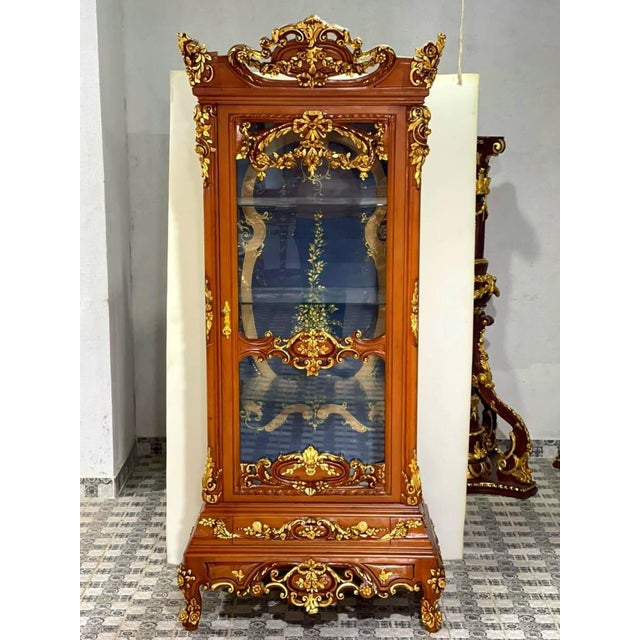 Elevate your home with the grandeur of this magnificent French Louis XV display cabinet, an extraordinary statement piece...