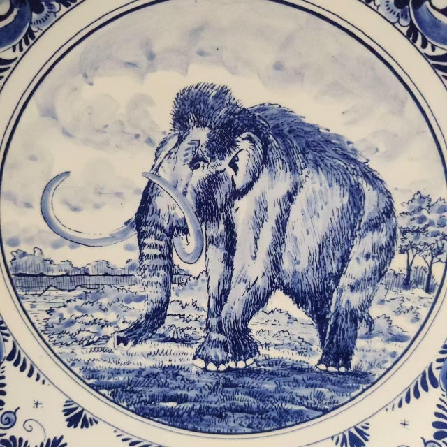 This Delft blue ceramic plate from the Netherlands features beautifully painted floral patterns and a mammoth motif,...