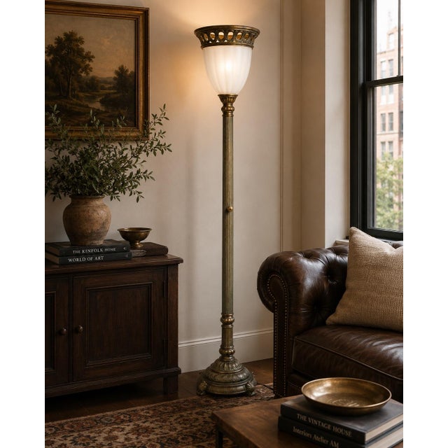 An elegant classical torchiere floor lamp featuring a richly detailed fluted column, sculptural weighted base, decorative...