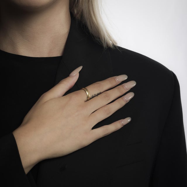 This vintage 14k yellow gold ring from the 1990’s features a smooth, lustrous band with a timeless design. The warm glow...