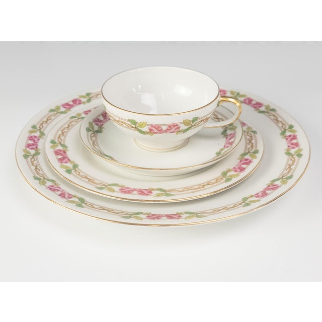An elegant four-piece Limoges porcelain place setting by W.M. Guerin & Co., produced in France between 1900 and 1930. The...