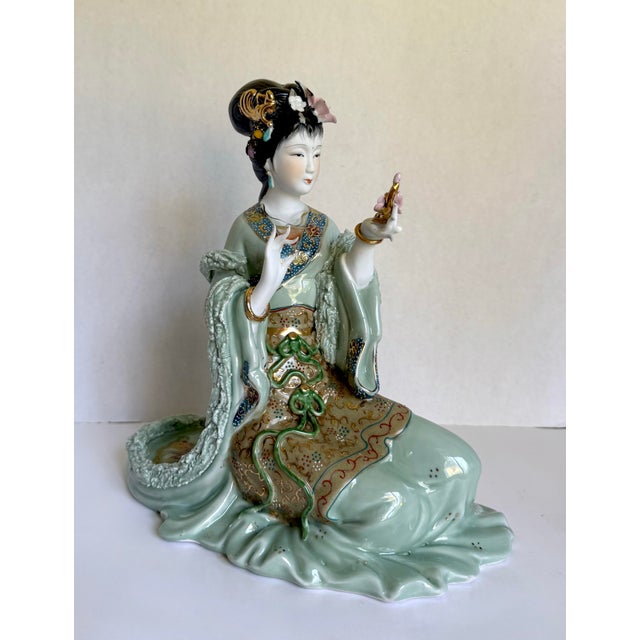 This vintage Chinese porcelain figure features a beautifully detailed seated court lady/maiden rendered in soft celadon...