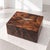 A refined 21st-century Bentley decorative box, crafted from figured wood and featuring the iconic Winged B logo applied to...