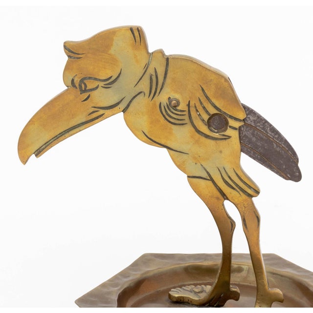 Ignatius Taschner (German, 1871-1913) Bird Form Cigar Cutter and Ashtray, circa 1900, hand-hammered brass and iron,...