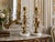 A pair of gorgeous Mid-Century Italian tole gilt floral candlesticks accented with beautiful crystals on marble bases,...