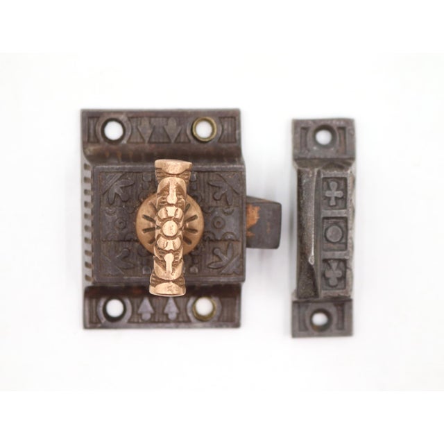 Aesthetic style cast iron ornate cabinet latch with a brass T shaped handle. The original mounting screws are not...