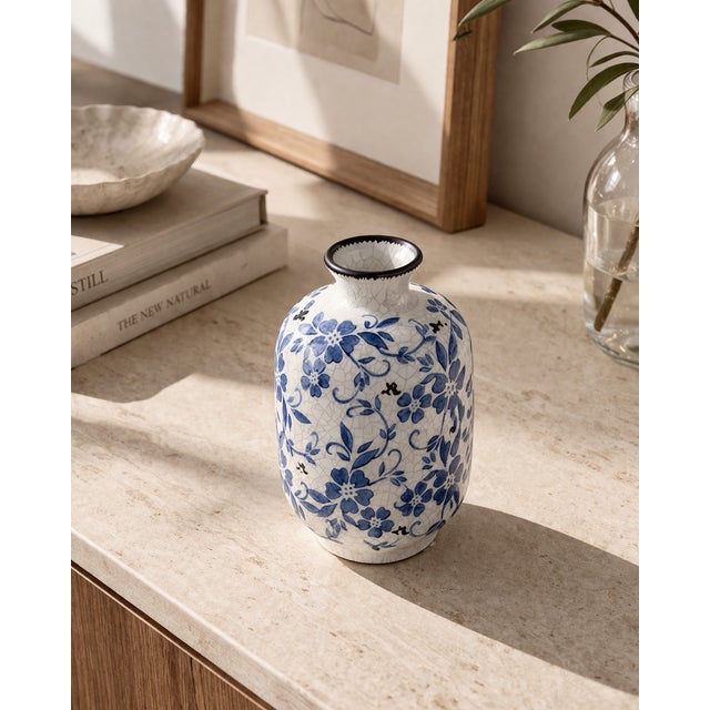 This blue and white crackle glaze vase brings a collected, decorative feel to a shelf, console, or tabletop. Its compact...
