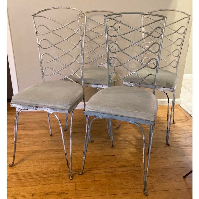 An elegant set of eight French wrought iron chairs in the manner of René Prou and dating from the late C20th. The Chairs...