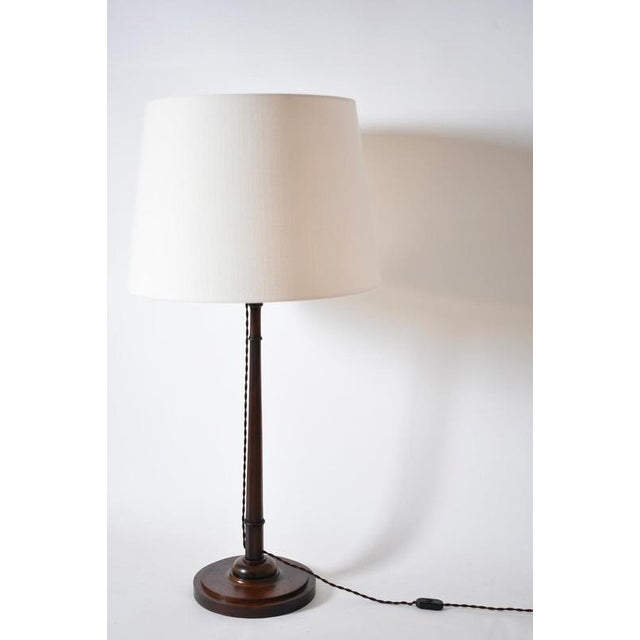 Wooden pyramidal lamp, 1920s. Wooden pyramidal lamp, on a circular base ornamented with a dome and supporting a conic...