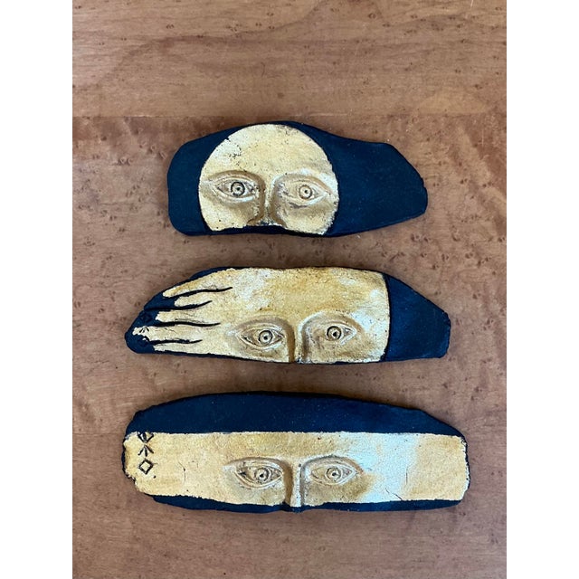 This enigmatic set of three vintage art pottery plaques offers a captivating blend of Surrealist influence and Brutalist...