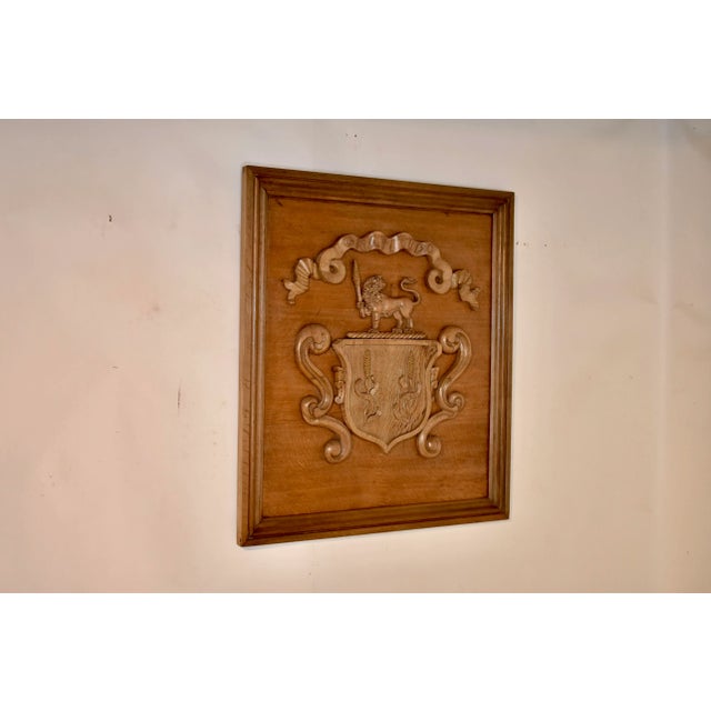 19th century oak hand carved framed armorial from England. The central design is of a shield with two wheat shafts,...