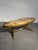 Elegant vintage coffee table featuring a stunning oval onyx top with beautiful natural veining in warm beige, honey and...