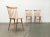 Three simple rung chairs in light wood. The construction of these chairs is particularly light and reminiscent of design...