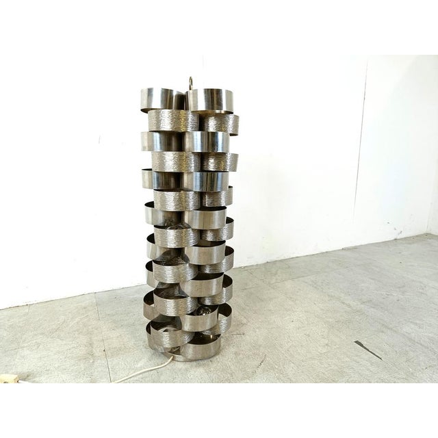 Sculptural floor lamp made of bent aluminum strips assembled in a very nice manner. Designed by Gaetano Sciolari but very...