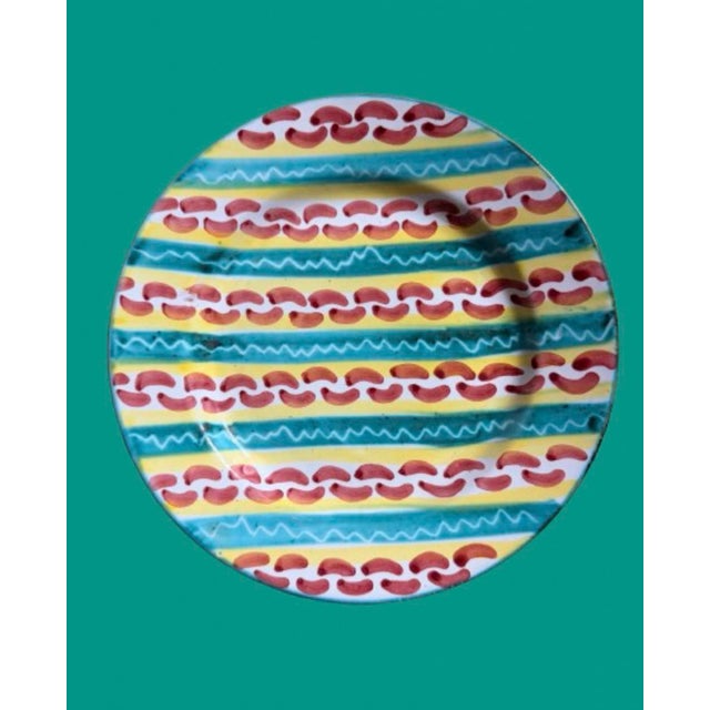 Vintage Italian handcrafted ceramic plates a colorful hand painted pink, yellow and turquoise colors on a white...