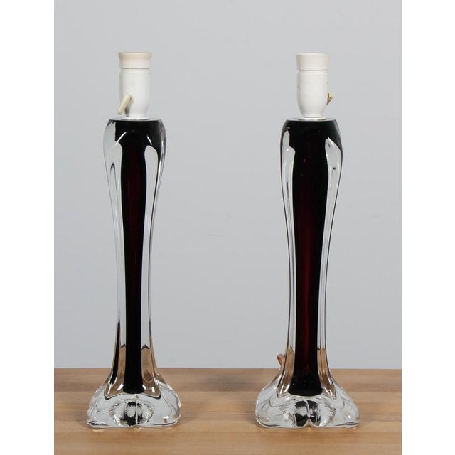 Pair of vintage table lamps, designed by Paul Kedelv for Flygfors in the 1960s, features a coloured and clear glass base....