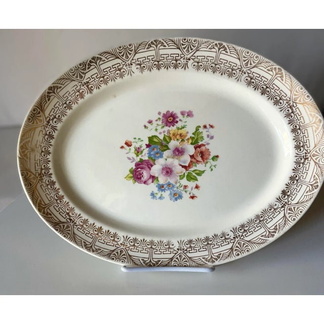 Go for the gold! This pretty 13" oval splatter features a colorful bouquet of flowers in the center, but what really makes...