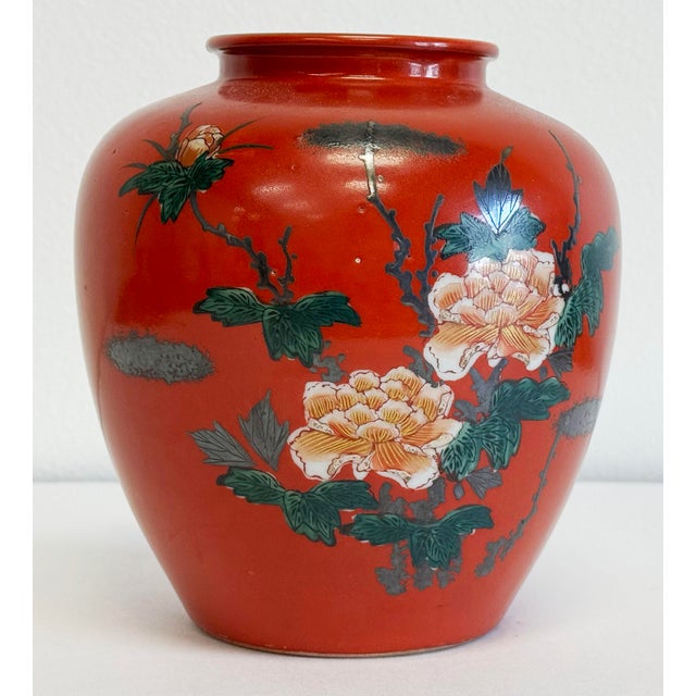 Vintage Kutani style Japanese porcelain vase with vibrant red body and hand-painted intricate floral and bird motif. Age...