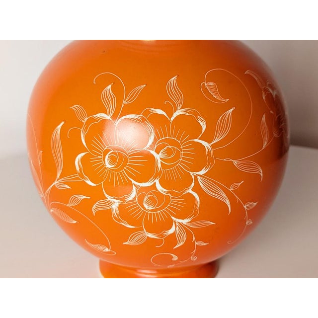 Medium-sized orange ceramic vase decorated with airbrush and graffito. The interior neck is decorated in gray with gold...