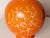 Medium-sized orange ceramic vase decorated with airbrush and graffito. The interior neck is decorated in gray with gold...