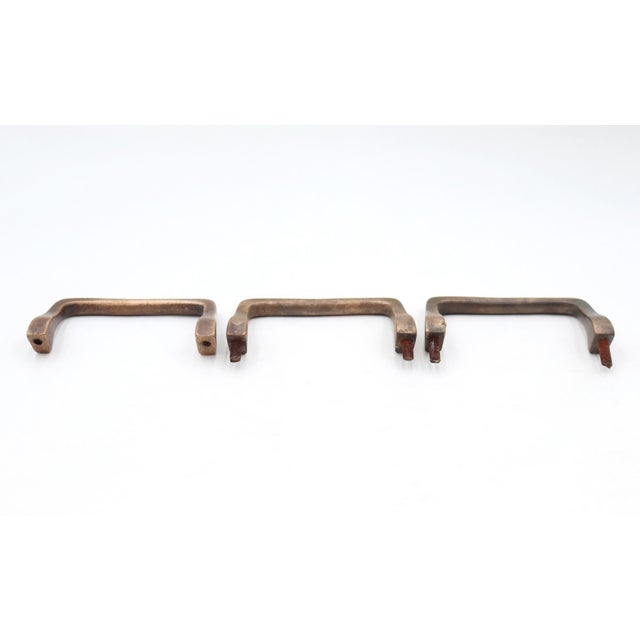 Vintage curved drawer or cabinet pulls made of brass with a patina finish. The mounting hardware is not included. Good...