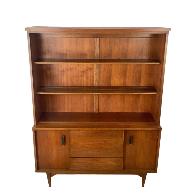 This handsome Mid-Century Modern walnut hutch exemplifies the clean architectural lines and functional elegance that...