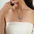 Crafted in 925 sterling silver, this elegant floral cluster pendant features 4.14 carats of oval-cut natural amethysts...