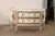A pair of nicely-sized, French style two-drawer raised commodes in white with gold accents. These vintage chests were made...