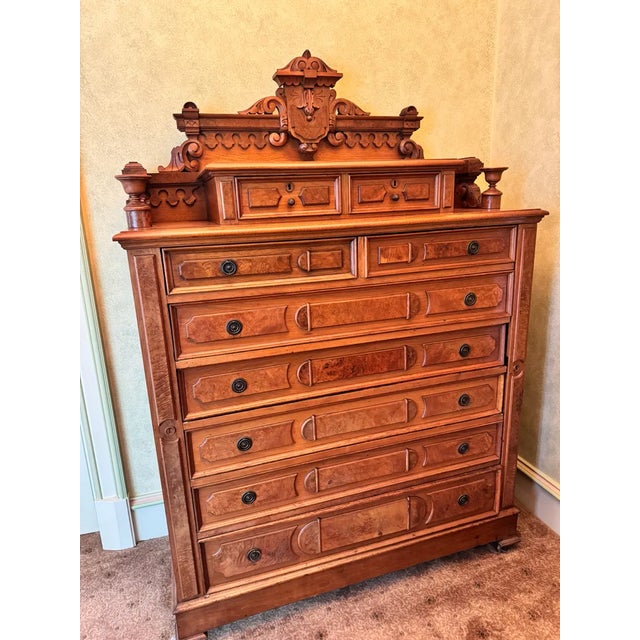 Eastlake lock side chest of drawers, circa 1870. The chest having a carved & spindled gallery surmounted with a pair of...