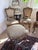 Elegant set of five vintage French Louis XV-style dining chairs accompanied by a coordinating upholstered stool, featuring...