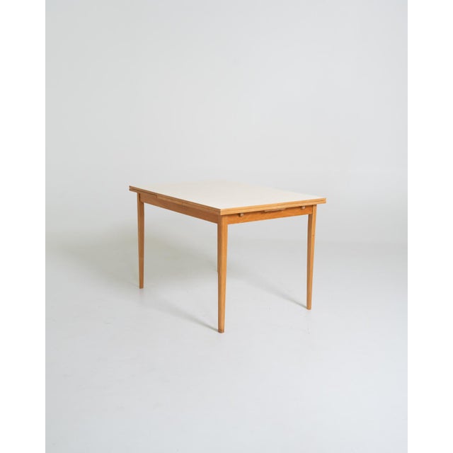 Beech frame with a rectangular tabletop covered in white Perstorp laminate and two 39 cm side extensions. Made in Sweden,...