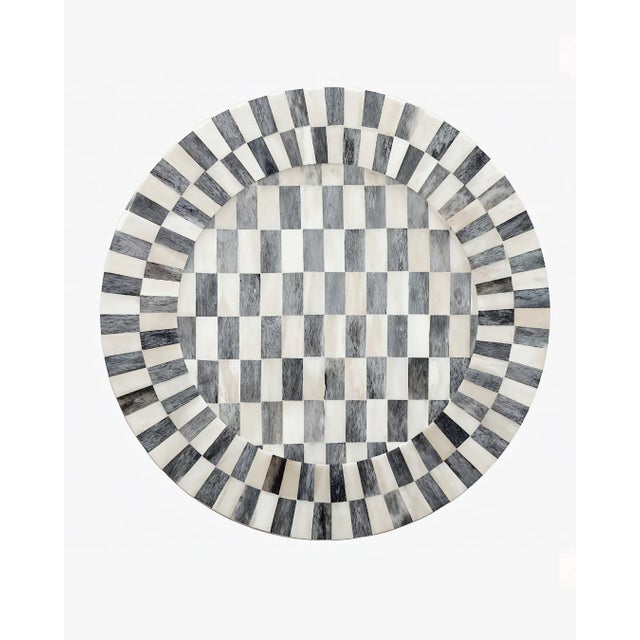 A striking foundation piece, our Bone Inlay Charger is designed to bring depth and artistry to the table. Featuring a...