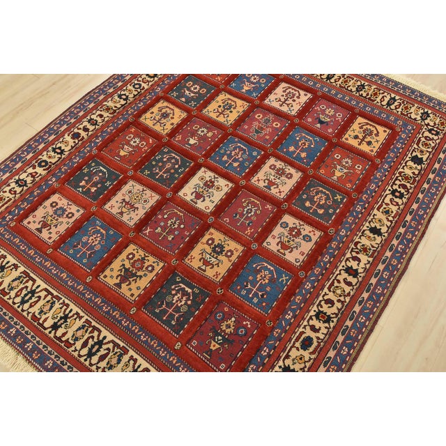 An authentic vintage tribal Gabbeh rug hand-knotted with fine wool and natural dyes. This oriental rug features a...