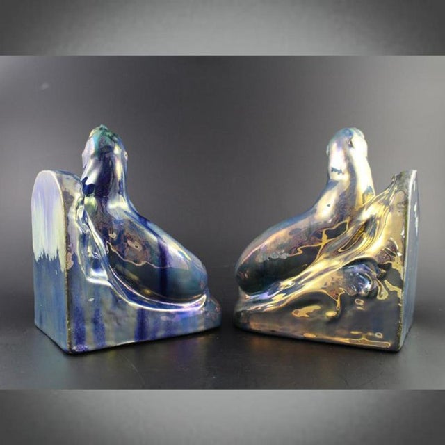 A pair of art deco bookends in the form of two ceramic basking seals by alphonse cytères (1851-1941) for rambervillers,...
