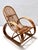 Made in Italy, 1970s. This rocking chair features a bamboo frame and its patterned fabric cushion, which has a soft...