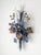 A stunning and rare pair of 1940's Italian tole electric wall sconces. The sconces feature a floral and leaf bouquet...