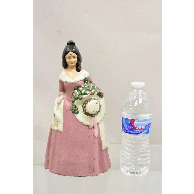Antique Victorian Tall Cast Iron Painted Figural Woman Pink Dress Door Stop. Circa Early 20th Century. Measurements: 11.5"...
